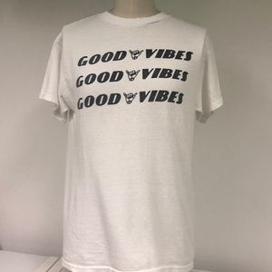 white brandy melville shirt that says “good vibes”